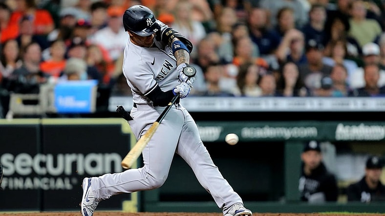 Jul 11, 2021; Houston, Texas, USA; New York Yankees shortstop Gleyber Torres (25) hits an RBI single to center field against the Houston Astros during the fifth inning at Minute Maid Park. Mandatory Credit: Erik Williams-USA TODAY Sports