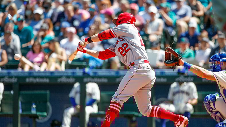 Jul 11, 2021; Seattle, Washington, USA; Los Angeles Angels second baseman David Fletcher (22) hits a two-run RBI single against the Seattle Mariners during the fifth inning at T-Mobile Park. Mandatory Credit: Jennifer Buchanan-USA TODAY Sports