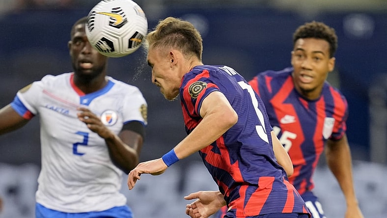Jul 11, 2021; Kansas City, Kansas, USA; United States defender Sam Vines (3) scores a goal as Haiti defender Carlens Arcus (2) defends in the first half during a CONCACAF Gold Cup group stage soccer match at Children's Mercy Park. Mandatory Credit: Jay Biggerstaff-USA TODAY Sports
