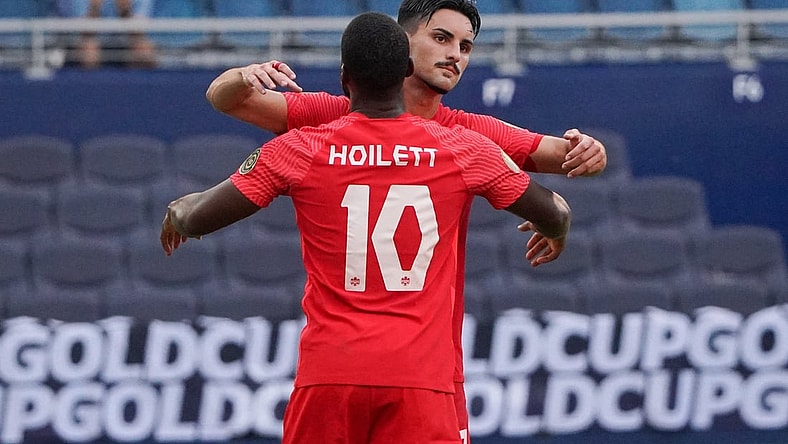 Jul 15, 2021; Kansas City, Kansas, USA; Canada forward Junior Hoilett (10) celebrates with midfielder Stephen Eustaquio (7) after scoring on a penalty kick against h during CONCACAF Gold Cup Soccer group stage play at Children's Mercy Park. Mandatory Credit: Denny Medley-USA TODAY Sports