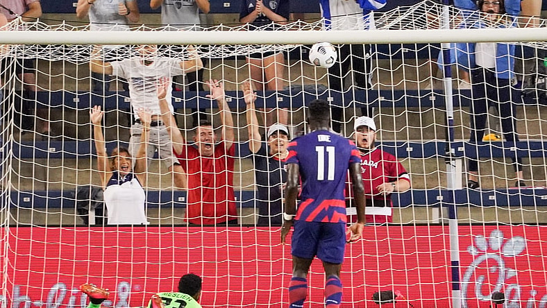 Jul 15, 2021; Kansas City, Kansas, USA; United States forward Daryl Dike (11) scores a goal as Martinique goalkeeper Meslien Gilles (23) looks on during CONCACAF Gold Cup Soccer group stage play at Children's Mercy Park. Mandatory Credit: Denny Medley-USA TODAY Sports