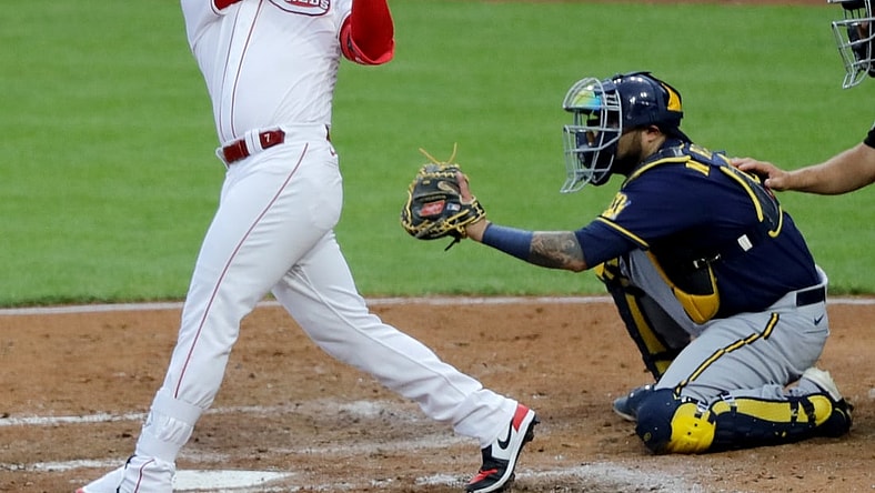 Jul 16, 2021; Cincinnati, Ohio, USA; Cincinnati Reds third baseman Eugenio Suarez (7) hits a two-run double against the Milwaukee Brewers during the third inning at Great American Ball Park. Mandatory Credit: David Kohl-USA TODAY Sports