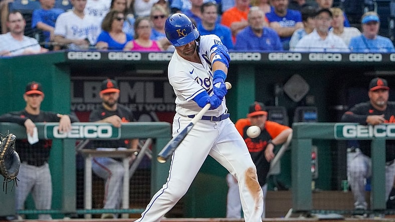 Jul 16, 2021; Kansas City, Missouri, USA; Kansas City Royals right fielder Whit Merrifield (15) hits a one-run sacrifice in the third inning against the Baltimore Orioles at Kauffman Stadium. Mandatory Credit: Denny Medley-USA TODAY Sports