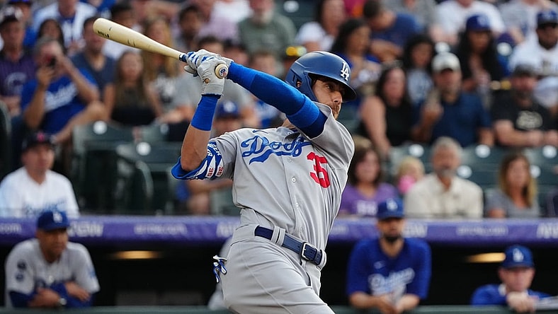 Jul 16, 2021; Denver, Colorado, USA; Los Angeles Dodgers center fielder Cody Bellinger (35) hits a two run RBI single in the first inning against the Colorado Rockies at Coors Field. Mandatory Credit: Ron Chenoy-USA TODAY Sports