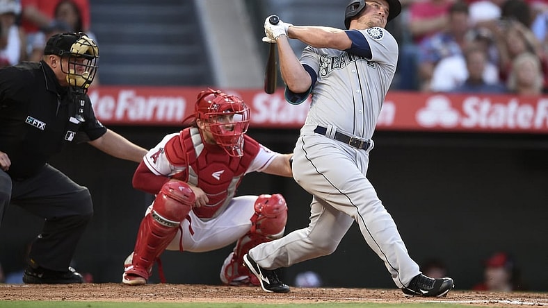 Jul 16, 2021; Anaheim, California, USA; Seattle Mariners third baseman Kyle Seager (15) follows through on a swing for a two-run home run during the third inning against the Los Angeles Angels at Angel Stadium. Mandatory Credit: Kelvin Kuo-USA TODAY Sports