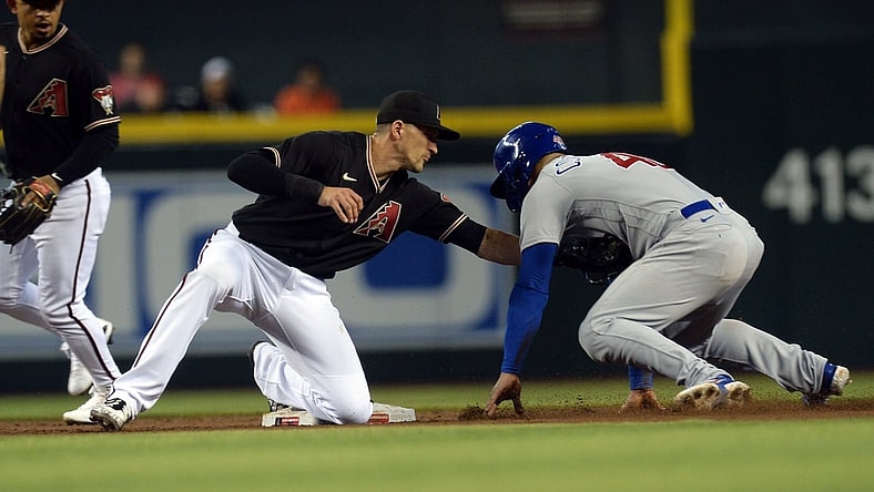 Jul 17, 2021; Phoenix, Arizona, USA; Arizona Diamondbacks shortstop Nick Ahmed (13) tags out Chicago Cubs catcher Willson Contreras (40) during a steal attempt during the third inning at Chase Field. Mandatory Credit: Joe Camporeale-USA TODAY Sports