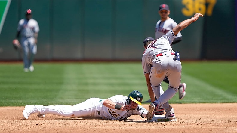 Jul 17, 2021; Oakland, California, USA;  Oakland Athletics left fielder Seth Brown (15) slides safely to second base during the second inning against Cleveland Indians shortstop Amed Rosario (1) at RingCentral Coliseum. Mandatory Credit: Stan Szeto-USA TODAY Sports