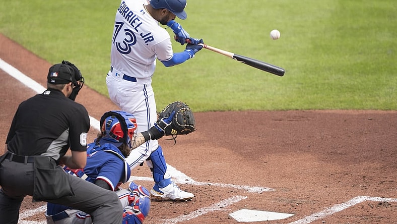Jul 18, 2021; Buffalo, New York, CAN; Toronto Blue Jays left fielder Lourdes Gurriel Jr. (13) hits a grand slam home run during the first inning against the Texas Rangers at Sahlen Field. Mandatory Credit: Gregory Fisher-USA TODAY Sports