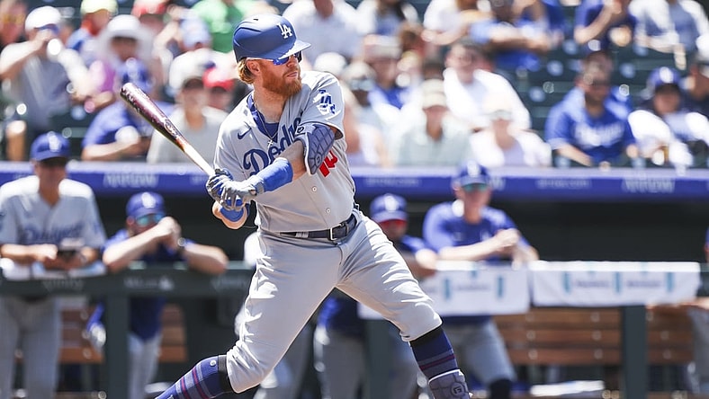 Jul 18, 2021; Denver, Colorado, USA; Los Angeles Dodgers third baseman Justin Turner (10) hits a two-run home run against the Colorado Rockies in the third inning at Coors Field. Mandatory Credit: Michael Ciaglo-USA TODAY Sports