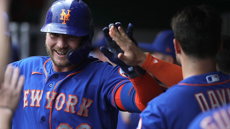Jul 19, 2021; Cincinnati, Ohio, USA; New York Mets first baseman Pete Alonso (20) celebrates in the dugout after hitting a two-run home run against the Cincinnati Reds during the first inning at Great American Ball Park. Mandatory Credit: David Kohl-USA TODAY Sports