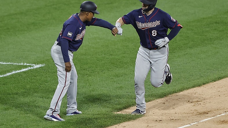 Jul 19, 2021; Chicago, Illinois, USA; Minnesota Twins center fielder Mitch Garver (8) celebrates with third base coach Tony Diaz (46) after hitting a solo home run against the Chicago White Sox during the fifth inning of a Game 2 of the doubleheader at Guaranteed Rate Field. Mandatory Credit: Kamil Krzaczynski-USA TODAY Sports