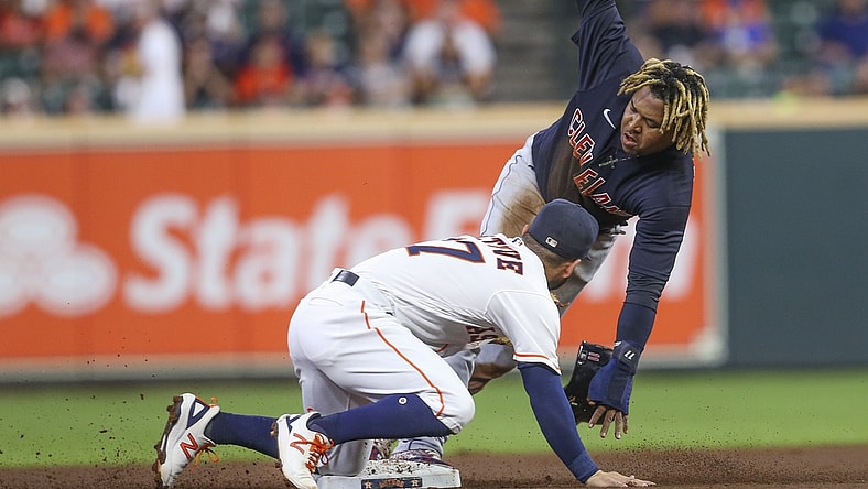 Jul 19, 2021; Houston, Texas, USA; Cleveland Indians third baseman Jose Ramirez (11) steals second base as Houston Astros second baseman Jose Altuve (27) applies the tag in the first inning Minute Maid Park. Mandatory Credit: Thomas Shea-USA TODAY Sports