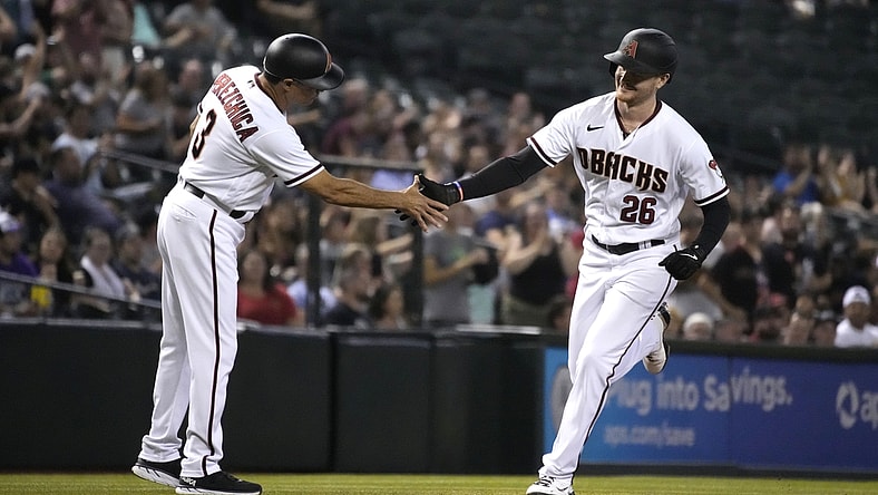 Jul 19, 2021; Phoenix, Arizona, USA; Arizona Diamondbacks first baseman Pavin Smith (26) celebrates with third base coach Tony Perezchica (3) after hitting a home run against the Pittsburgh Pirates in the second inning at Chase Field. Mandatory Credit: Rick Scuteri-USA TODAY Sports