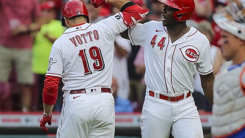 Jul 20, 2021; Cincinnati, Ohio, USA; Cincinnati Reds first baseman Joey Votto (19) reacts after hitting a solo home run with right fielder Aristides Aquino (44) in the third inning against the New York Mets at Great American Ball Park. Mandatory Credit: Katie Stratman-USA TODAY Sports