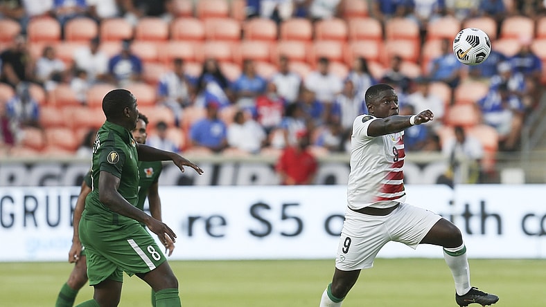 Jul 20, 2021; Houston, Texas, USA; Suriname  forward Nigel Hasselbaink (9) heads the ball against Guadeloupe in the second half during a CONCACAF Gold Cup group stage soccer match at BBVA Stadium. Mandatory Credit: Thomas Shea-USA TODAY Sports