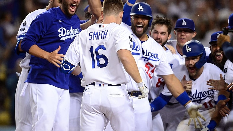 Jul 20, 2021; Los Angeles, California, USA; Los Angeles Dodgers catcher Will Smith (16) is greeted at home by pitcher Clayton Kershaw (22) and first baseman Albert Pujols (55) after hitting a walk off three run home run against the San Francisco Giants during the ninth inning at Dodger Stadium. Mandatory Credit: Gary A. Vasquez-USA TODAY Sports