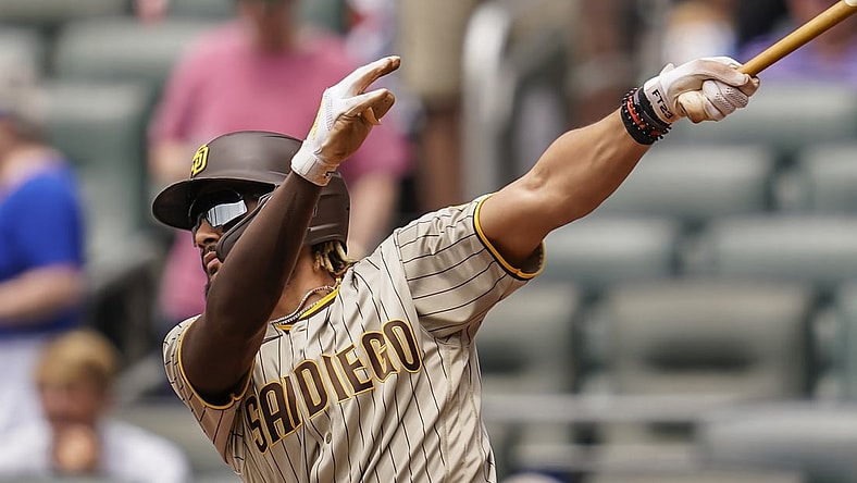 Jul 21, 2021; Cumberland, Georgia, USA; San Diego Padres shortstop Fernando Tatis Jr. (23) singles against the Atlanta Braves during the first inning at Truist Park. Mandatory Credit: Dale Zanine-USA TODAY Sports