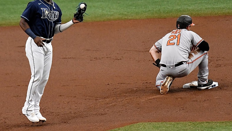Jul 21, 2021; St. Petersburg, Florida, USA; Tampa Bay Rays second baseman Vidal Brujan (left) reacts after turning a double play in the first inning against the Baltimore Orioles at Tropicana Field. Mandatory Credit: Jonathan Dyer-USA TODAY Sports