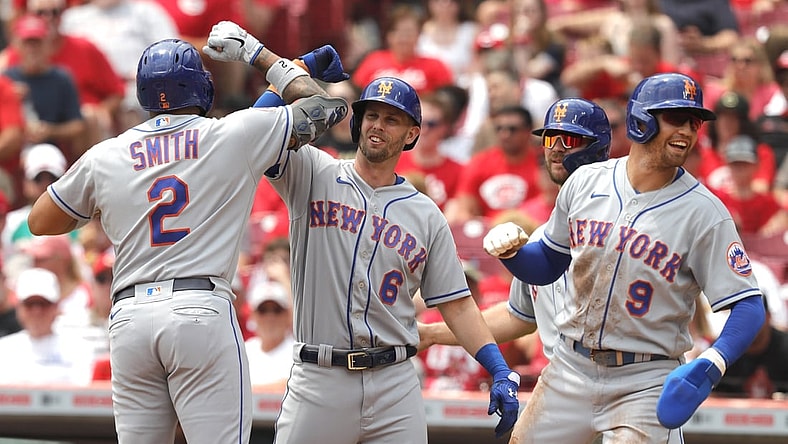 Jul 21, 2021; Cincinnati, Ohio, USA; New York Mets left fielder Dominic Smith (2) celebrates with second baseman Jeff McNeil (6) center fielder Brandon Nimmo (9) and first baseman Pete Alonso (20) after hitting a grand slam home run against the Cincinnati Reds in the third inning at Great American Ball Park. Mandatory Credit: David Kohl-USA TODAY Sports