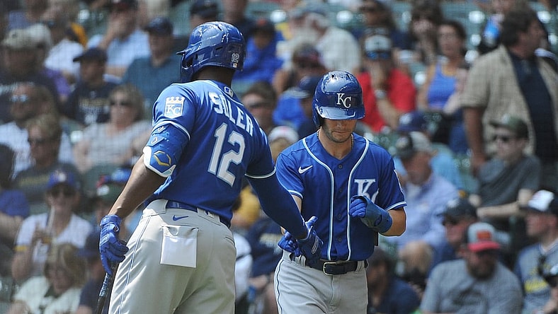 Jul 21, 2021; Milwaukee, Wisconsin, USA; Kansas City Royals right fielder Jorge Soler (12) congratulates left fielder Andrew Benintendi (right) after scoring a run against the Milwaukee Brewers in the fourth inning at American Family Field. Mandatory Credit: Michael McLoone-USA TODAY Sports