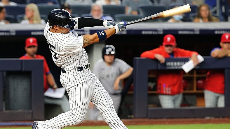 Jul 21, 2021; Bronx, New York, USA; New York Yankees shortstop Gleyber Torres (25) hits a solo home run against the Philadelphia Phillies during the fourth inning at Yankee Stadium. Mandatory Credit: Andy Marlin-USA TODAY Sports