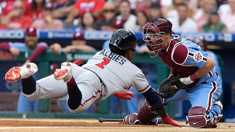Jul 22, 2021; Philadelphia, Pennsylvania, USA; Atlanta Braves second baseman Ozzie Albies (1) slides into home past the tag attempt of Philadelphia Phillies catcher Andrew Knapp (5) for a run during the first inning at Citizens Bank Park. Mandatory Credit: Bill Streicher-USA TODAY Sports