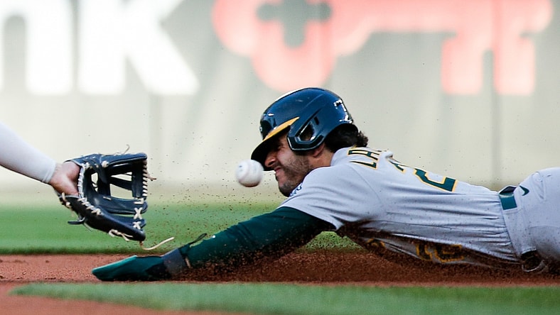 Jul 23, 2021; Seattle, Washington, USA; Oakland Athletics center fielder Ramon Laureano (22) is caught trying to steal second base during the second inning at T-Mobile Park. Mandatory Credit: Jennifer Buchanan-USA TODAY Sports