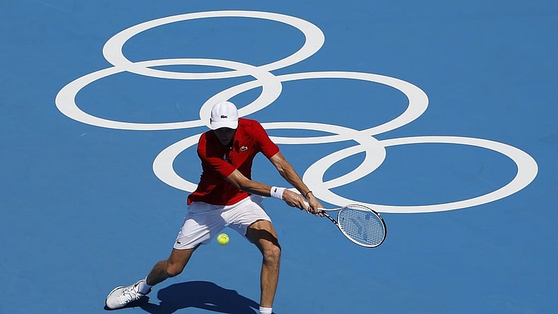 Jul 24, 2021; Tokyo, Japan; Daniil Medvedev of the Russian Olympic Committee hits a backhand against Alexander Bublik of Kazakhstan (not pictured) in a first round men's singles match during the Tokyo 2020 Olympic Summer Games at Ariake Tennis Park. Mandatory Credit: Geoff Burke-USA TODAY Network