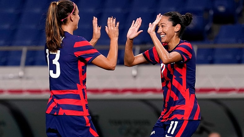 Jul 24, 2021; Saitama, Japan; United States forward Christen Press (11) celebrates her goal against New Zealand with forward Alex Morgan (13) during the second half in group G play during the Tokyo 2020 Olympic Summer Games at Saitama Stadium. Mandatory Credit: Jack Gruber-USA TODAY Network