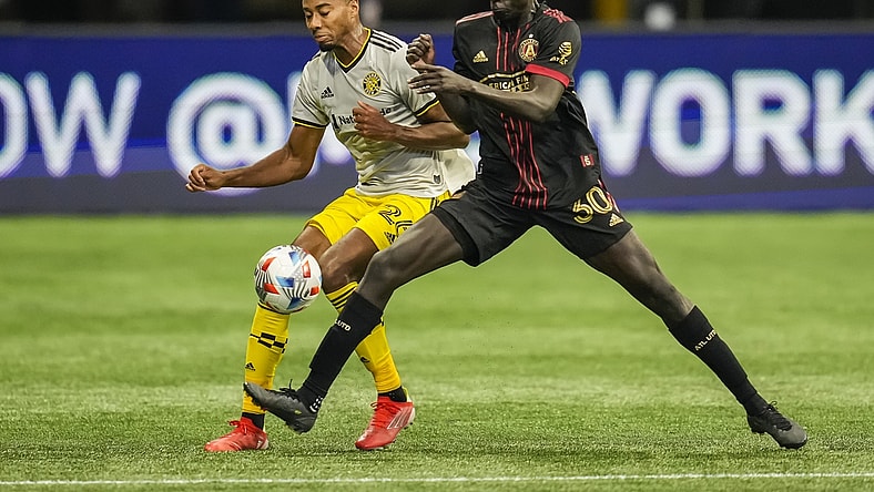 Jul 24, 2021; Atlanta, Georgia, USA; Columbus Crew defender Saad Abdul-Salaam (26) and Atlanta United forward Machop Chol (30) battle for control of the ball during the first half at Mercedes-Benz Stadium. Mandatory Credit: Dale Zanine-USA TODAY Sports