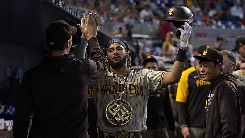 Jul 24, 2021; Miami, Florida, USA; San Diego Padres shortstop Fernando Tatis Jr. (23) celebrates his solo homerun in the dugout while wearing the swag chain in the 1st inning against the Miami Marlins at loanDepot park. Mandatory Credit: Jasen Vinlove-USA TODAY Sports