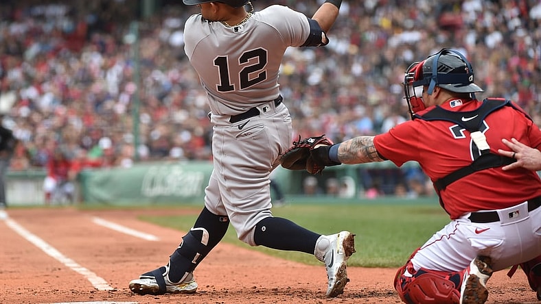 Jul 25, 2021; Boston, Massachusetts, USA;  New York Yankees second baseman Rougned Odor (12) hits an RBI single during the third inning against the Boston Red Sox at Fenway Park. Mandatory Credit: Bob DeChiara-USA TODAY Sports