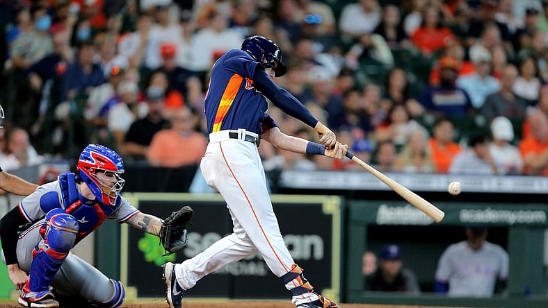 Jul 25, 2021; Houston, Texas, USA; Houston Astros right fielder Kyle Tucker (30) hits an RBI single against the Texas Rangers during the sixth inning at Minute Maid Park. Mandatory Credit: Erik Williams-USA TODAY Sports