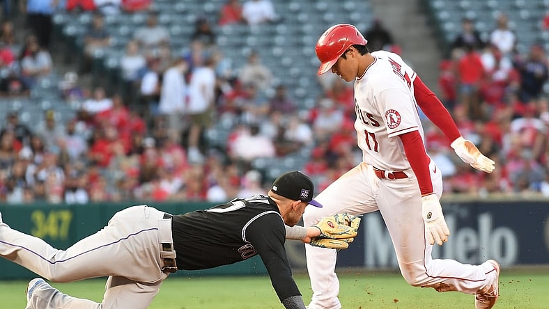 Jul 26, 2021; Anaheim, California, USA; Los Angeles Angels starting pitcher Shohei Ohtani (17) steals second against Colorado Rockies shortstop Trevor Story (27) during the first inning at Angel Stadium. Mandatory Credit: Richard Mackson-USA TODAY Sports