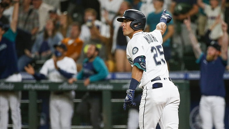 Jul 26, 2021; Seattle, Washington, USA; Seattle Mariners shortstop Dylan Moore (25) hits a grand-slam home run against the Houston Astros during the eighth inning at T-Mobile Park. Mandatory Credit: Joe Nicholson-USA TODAY Sports