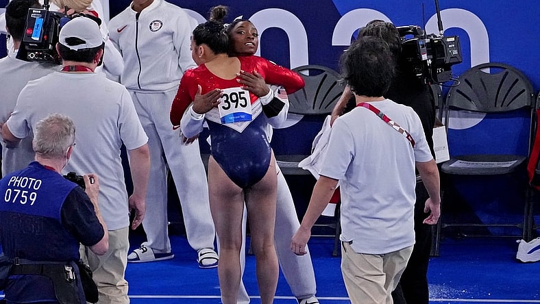 Jul 27, 2021; Tokyo, Japan; Sunisa Lee (USA) reacts with Simone Biles (USA) in the women's team final during the Tokyo 2020 Olympic Summer Games at Ariake Gymnastics Centre. Mandatory Credit: Robert Deutsch-USA TODAY Sports