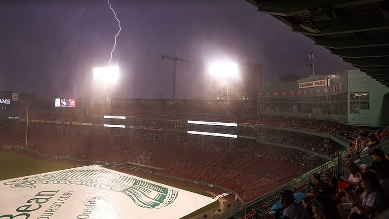 Jul 27, 2021; Boston, Massachusetts, USA; Lightning strikes outside Fenway Park during a rain delay between the Toronto Blue Jays and the Boston Red Sox. Mandatory Credit: Paul Rutherford-USA TODAY Sports