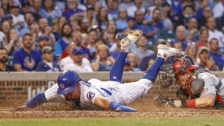 Jul 27, 2021; Chicago, Illinois, USA; Cincinnati Reds catcher Tyler Stephenson (37) tags out at home plate Chicago Cubs left fielder Rafael Ortega (66) during the third inning at Wrigley Field. Mandatory Credit: Kamil Krzaczynski-USA TODAY Sports