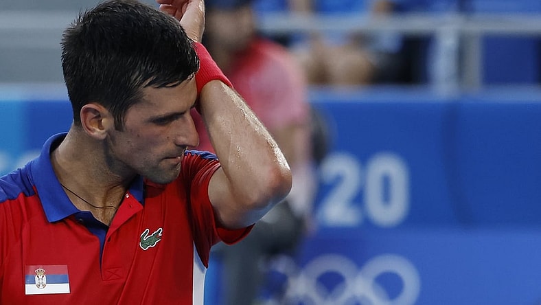 Jul 28, 2021; Tokyo, Japan; Novak Djokovic of Serbia wipes his face between points against Alejandro Davidovich Fokina of Spain (not pictured) in a mens' singles round of sixteen match during the Tokyo 2020 Olympic Summer Games at Ariake Tennis Park. Mandatory Credit: Geoff Burke-USA TODAY Sports