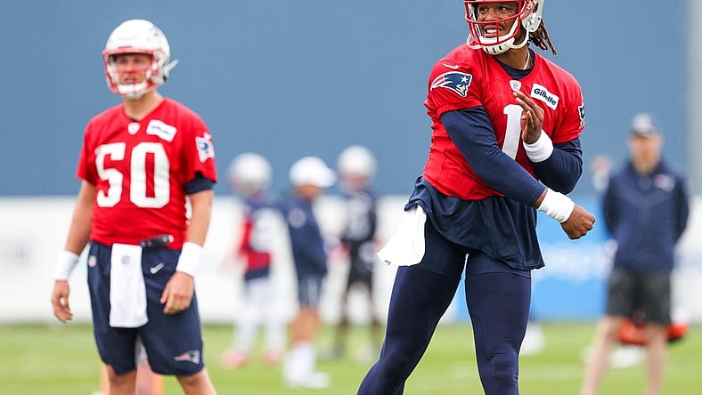Jul 28, 2021; Foxborough, MA, United States; New England Patriots quarterback Mac Jones (50) watches New England Patriots quarterback Cam Newton (1) during training camp at Gillette Stadium. Mandatory Credit: Paul Rutherford-USA TODAY Sports