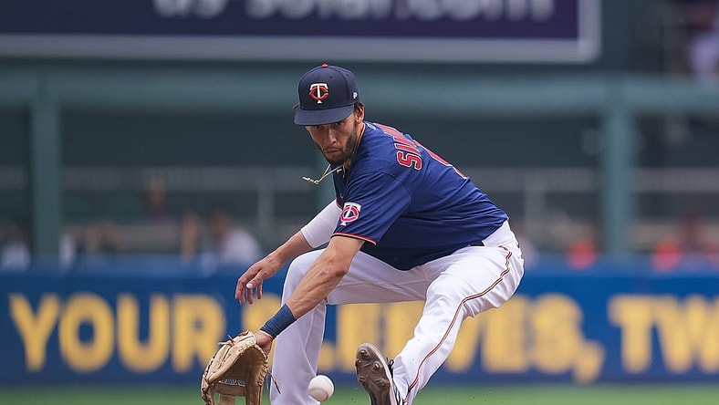 Jul 28, 2021; Minneapolis, Minnesota, USA; Minnesota Twins shortstop Andrelton Simmons (9) fields a ground ball against the Detroit Tigers in the fourth inning at Target Field. Mandatory Credit: Brad Rempel-USA TODAY Sports