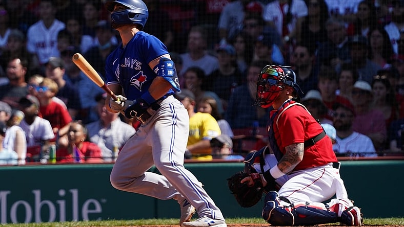 Jul 28, 2021; Boston, Massachusetts, USA; Toronto Blue Jays center fielder Randal Grichuk (15) hits a two run home run against the Boston Red Sox in the fourth inning at Fenway Park. Mandatory Credit: David Butler II-USA TODAY Sports