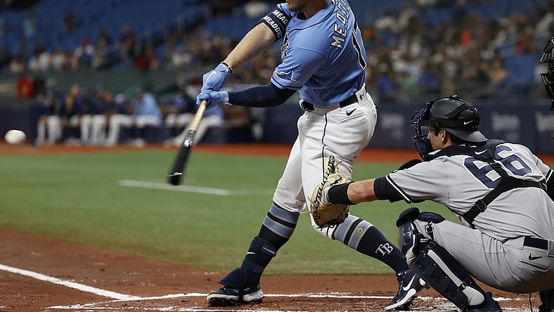 Jul 29, 2021; St. Petersburg, Florida, USA;  Tampa Bay Rays designated hitter Austin Meadows (17) hits a three-run home run during the first inning against the New York Yankees at Tropicana Field. Mandatory Credit: Kim Klement-USA TODAY Sports