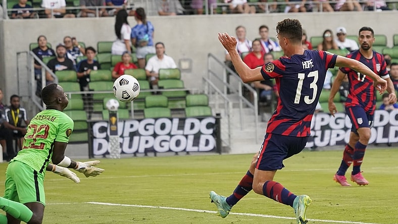 Jul 29, 2021; Austin, Texas, USA; United States forward Matthew Hoppe (13) shoots on goal as Qatar goalkeeper goalkeeper Meshaal Barsham (22) makes the save in the first half of a Concacaf Gold Cup semifinal soccer match at Q2 Stadium. Mandatory Credit: Scott Wachter-USA TODAY Sports