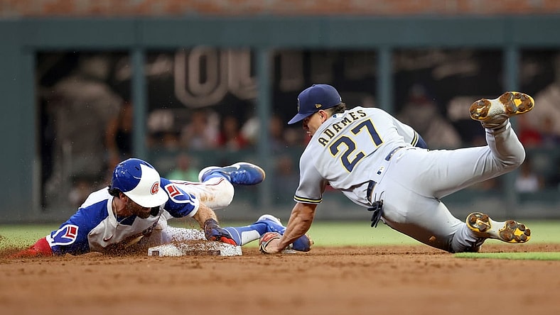 Jul 30, 2021; Atlanta, Georgia, USA; Atlanta Braves shortstop Dansby Swanson (7) steals second base ahead of the tag by Milwaukee Brewers shortstop Willy Adames (27) during the first inning at Truist Park. Mandatory Credit: Jason Getz-USA TODAY Sports