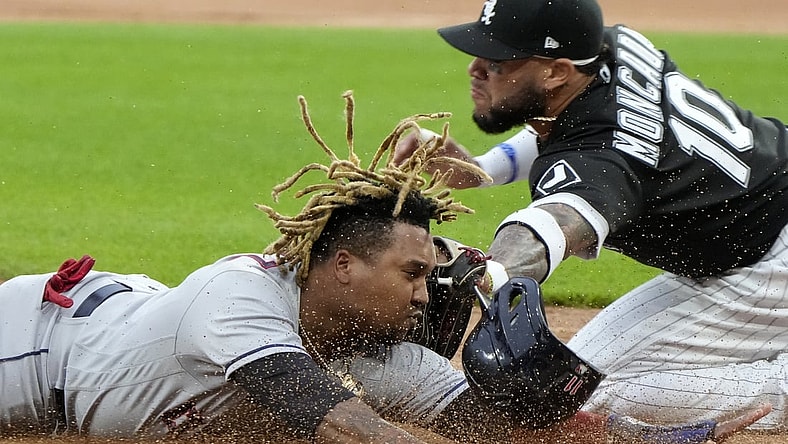 Jul 30, 2021; Chicago, Illinois, USA; Chicago White Sox third baseman Yoan Moncada (10) tags out Cleveland Indians third baseman Jose Ramirez (11) at third base during the first inning at Guaranteed Rate Field. Mandatory Credit: Mike Dinovo-USA TODAY Sports