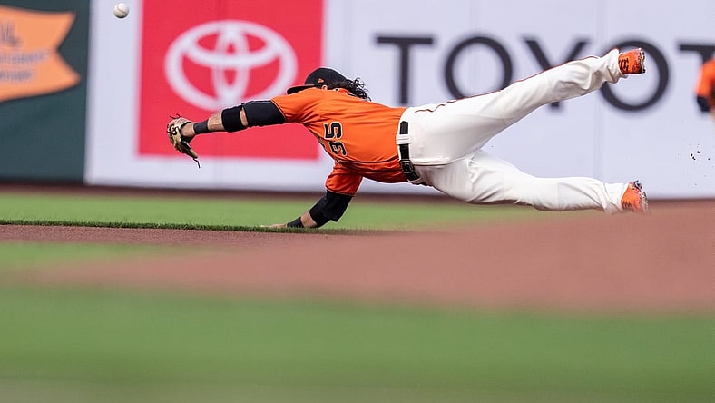 Jul 30, 2021; San Francisco, California, USA;  San Francisco Giants shortstop Brandon Crawford (35) dives but cannot catch the baseball during the first inning against the Houston Astros at Oracle Park. Mandatory Credit: Neville E. Guard-USA TODAY Sports