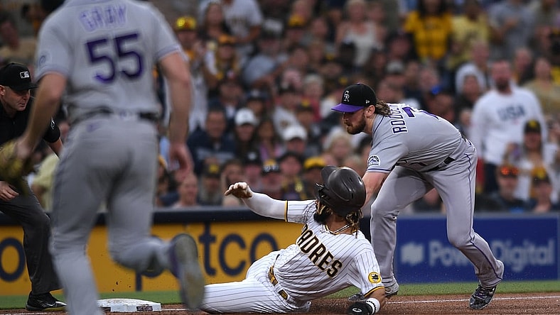 Jul 30, 2021; San Diego, California, USA; Colorado Rockies shortstop Brendan Rodgers (7) tags out San Diego Padres shortstop Fernando Tatis Jr. (center) at third base during the first inning at Petco Park. Tatis was injured on the play. Mandatory Credit: Orlando Ramirez-USA TODAY Sports