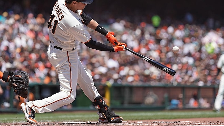 Jul 31, 2021; San Francisco, California, USA; San Francisco Giants second baseman Wilmer Flores (41) hits a RBI home run during the third inning against the Houston Astros at Oracle Park. Mandatory Credit: Stan Szeto-USA TODAY Sports
