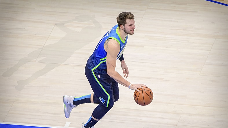 Jan 8, 2020; Dallas, Texas, USA; Dallas Mavericks forward Luka Doncic (77) and the shadow outline of former player Dirk Nowitzki during the game between the Mavericks and the Nuggets at the American Airlines Center. Mandatory Credit: Jerome Miron-USA TODAY Sports